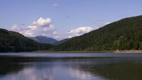 Sunset in the Mountains with Clouds and Reflection in the Lake Water Stock Photos