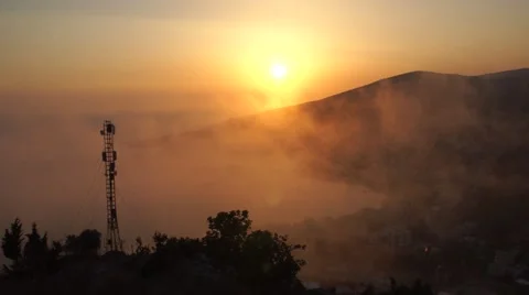 Sunset in the mountains, the clouds go fast, on a background of mountains Stock Footage 67421854
