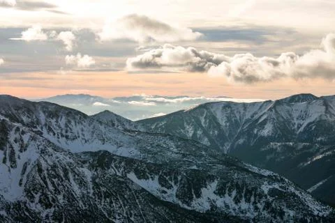 Sunset in the mountains, orange sunset, clouds, sky and mountains Stock Photos