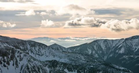 Sunset in the mountains, orange sunset, clouds, sky and mountains Stock Photos