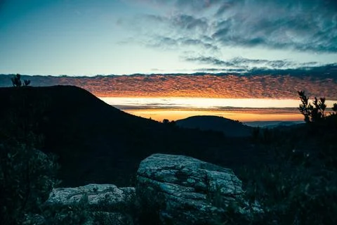 Sunset in the mountains. Rocks and clouds Stock Photos