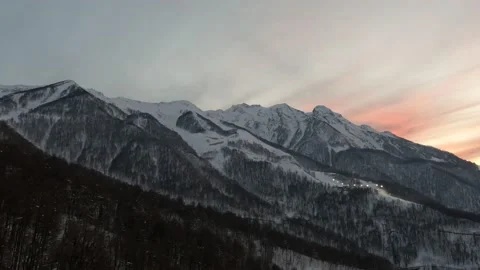 Sunset in the mountains of the ski resort, drone flight at sunset in the clouds. Video stock 177372878