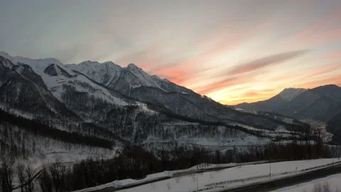 Sunset in the mountains of the ski resort, drone flight at sunset in the clouds. Video stock 177373301