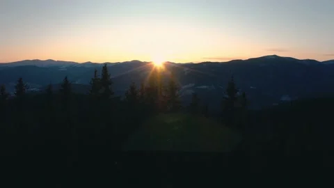 Sunset in the mountains through the trees top view. Stock Footage 144239524