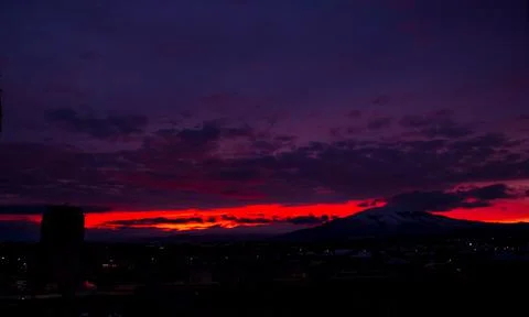 Sunset in the mountains, time lapse of clouds over the city Stock Photos