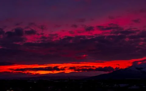 Sunset in the mountains, time lapse of clouds over the city 스톡 사진