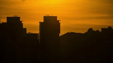 Sunset moving behind building  with colorful cloudy sky located at center of  Stock Footage 133015080