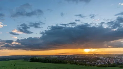 Sunset with moving clouds and rain Stock Footage 132956054