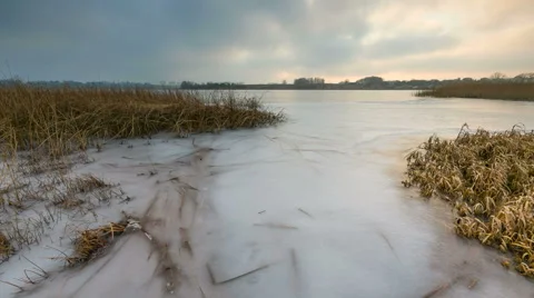 Sunset with moving clouds over frozen lake in Poland. Timelapse Stock Footage 58651894
