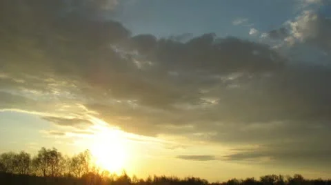 Sunset with moving clouds timelapse Stock Footage 10756142