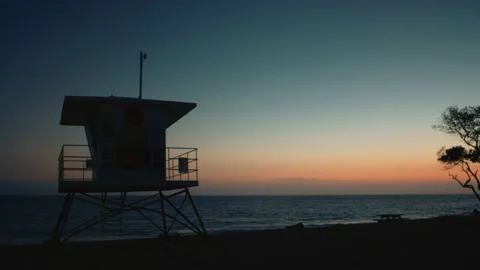 Sunset next to bay watch tower 스톡 동영상 136428002