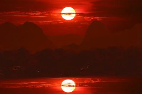 Sunset on night red sky back over silhouette tree mountain Stock Photos