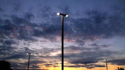 Sunset to Night Timelapse with Three Light Posts Turning On Stock Footage 107615795