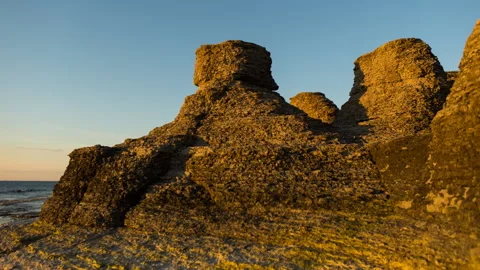 From sunset to nightfall at a rocky beach Stock Footage 205216597