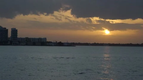 Sunset at Normandy Isles in Miami Beach with a boat and jetski Video stock 134853680