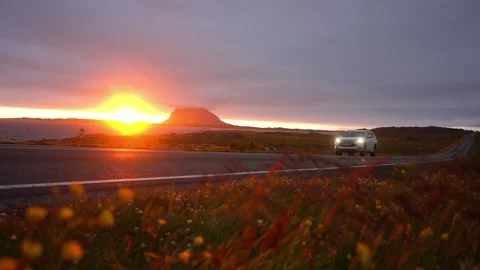 Sunset in Norway, field view of a passing SUV Stock Footage 224241430
