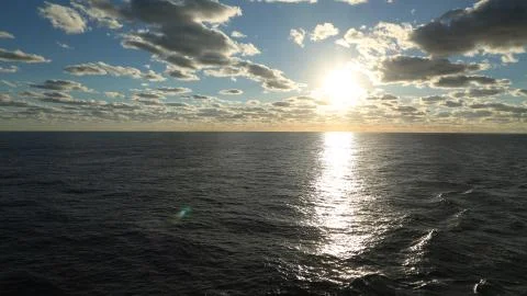 Sunset on the ocean and cloudy sky Foto stock