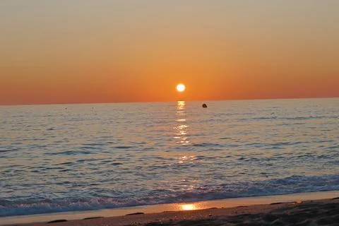 Sunset ocean beach Stock Photos