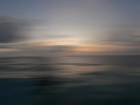 Sunset in the ocean in a blur of motion Stock Illustration