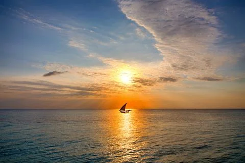 Sunset in the ocean with boat Stock Photos
