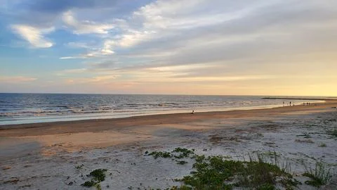 Sunset at the ocean with cloud and beach Stock Photos
