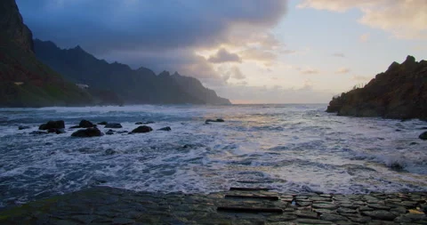 Sunset into the ocean. High tide. Waves crash on rocks and spray in beautiful Stock Footage 198401098