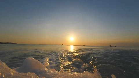 Sunset in the ocean with incoming waves  in half speed framerate front view Stock-Footage 90005311