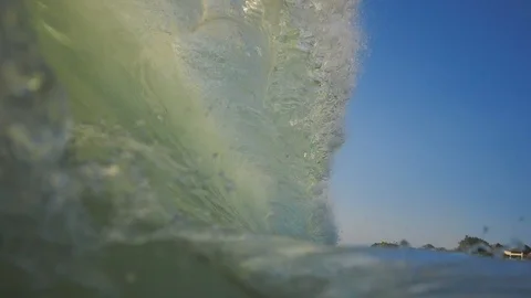 Sunset in the ocean with incoming waves  in slowmotion Stock Footage 90004811