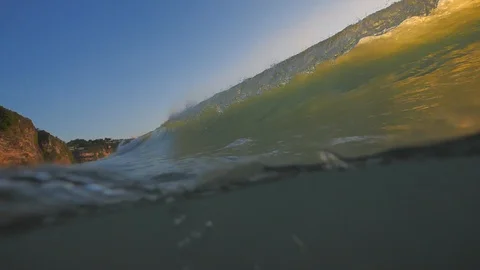 Sunset in the ocean with incoming waves  in slowmotion Stock Footage 90005320