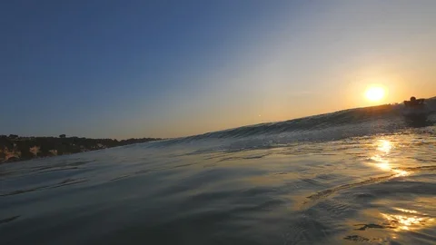 Sunset in the ocean with incoming waves  in slowmotion front view Video stock 90005409