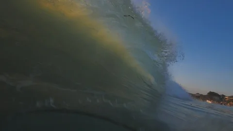Sunset in the ocean with incoming waves  in slowmotion Stock-Footage 90005499