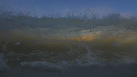 Sunset in the ocean with incoming waves  in slowmotion Stock Footage 90005772