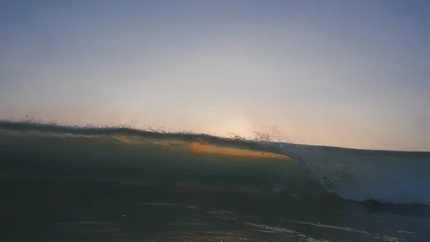 Sunset in the ocean with incoming waves  in slowmotion Stock Footage 90006159
