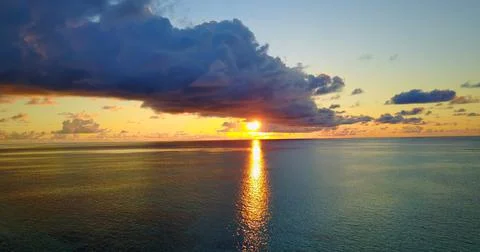 Sunset on the ocean with large clouds Stock Photos