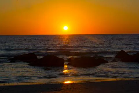 Sunset on ocean Stock Photos