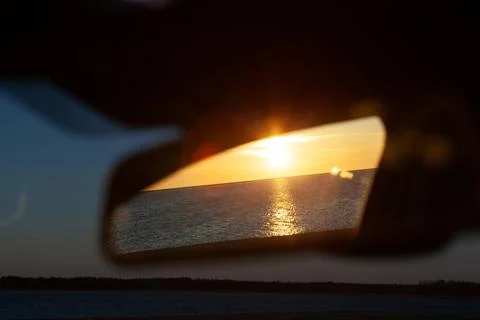 Sunset ocean reflection in rear view mirror Stock Photos