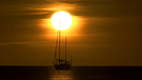Sunset on the Ocean with sailing boat Stock Footage 104938951