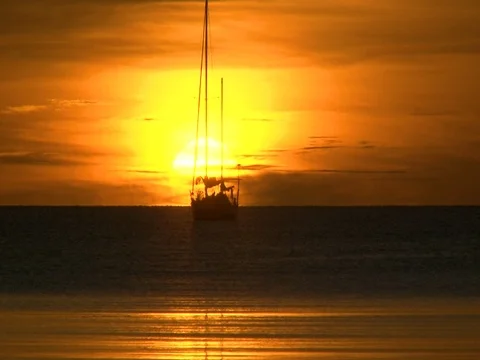 Sunset on the Ocean with sailing boat2 Stock Footage 104938889