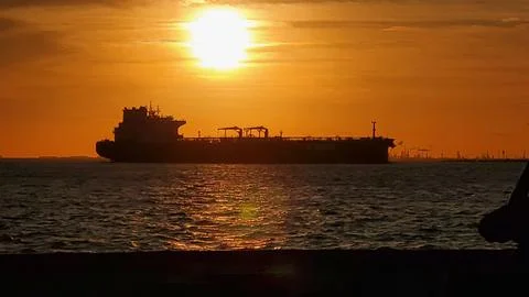 Sunset on ocean with a ship Foto stock