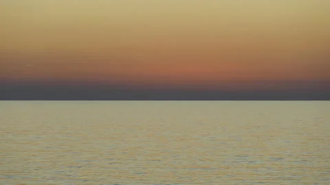 Sunset into the ocean with silhouettes of some small boats time lapse Stock Footage 209337393
