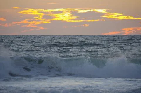 Sunset ocean surf Stock Photos