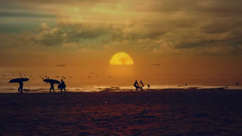 Sunset Ocean Surfers Sand Beach Sun Setting Down Horizon Stock Footage 185992161