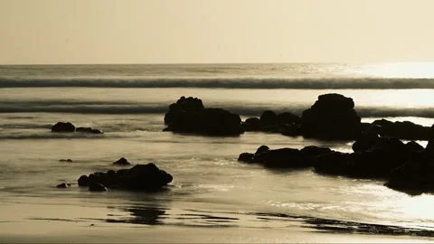 Sunset ocean timelapse with soft motion-blurred waves and rocks in distance Stock Footage 309913351