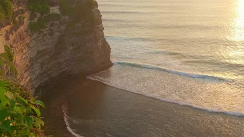 Sunset Ocean View from High Cliff at Uluwatu Bali with Rolling Waves Stock Footage 339908139