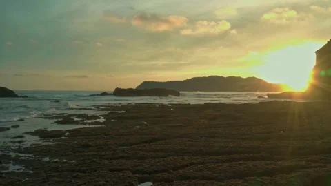 Sunset ocean view, rocky beach sunset, golden hour seascape Stock Footage 311785746