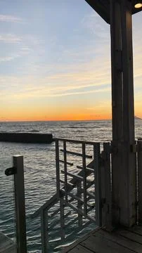 Sunset Ocean View from a Seaside Cafe Deck Stock Photos