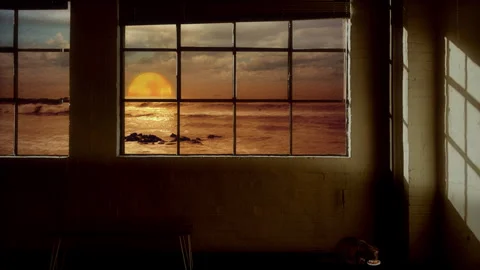 Sunset Ocean View Through Industrial Window With Cat Resting in Warm Interior Vídeos de archivo 341857737