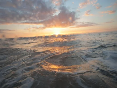 Sunset in the ocean. Water level shot Stock Footage 80174699