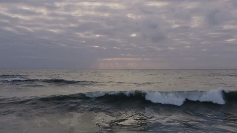 Sunset ocean waves break towards aerial camera Stock Footage 112694181