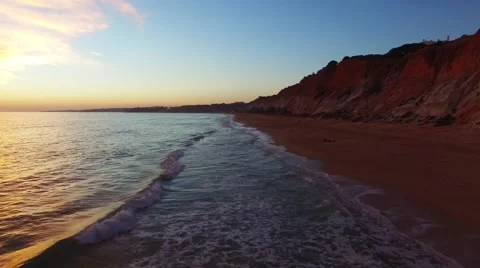 Sunset at oceanside cliffs beach aerial Portugal Algarve aerial view Video stock 58949831
